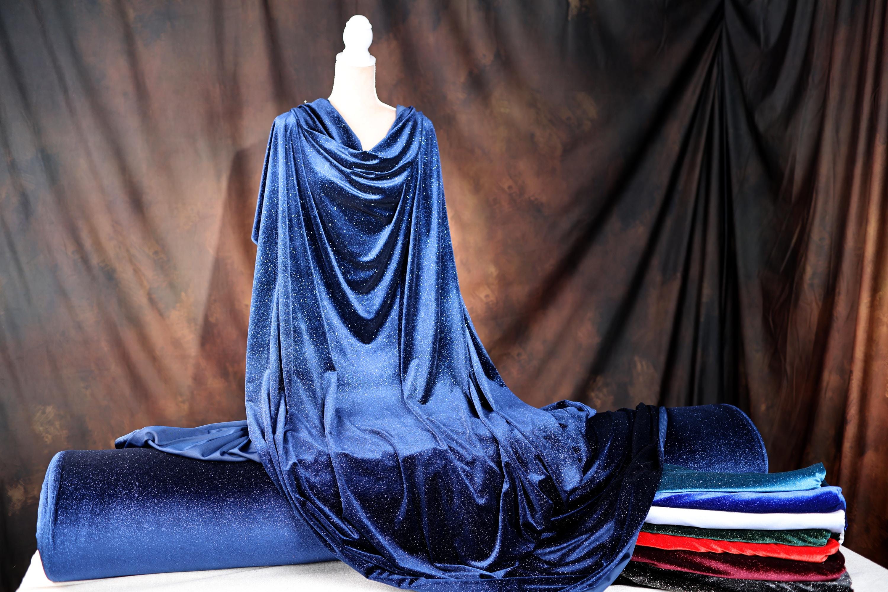a mannequin dressed in a blue cloak on a table