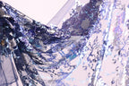 a close-up view of a fabric with a vibrant, multicolored pattern of sequins and threads, creating a visually striking and intricate design.