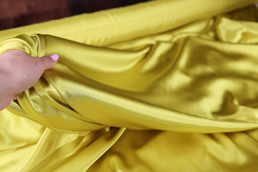 a person holding a yellow cloth in their hand
