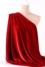 A red velvet fabric draped over a mannequin head, creating a dramatic and elegant display.