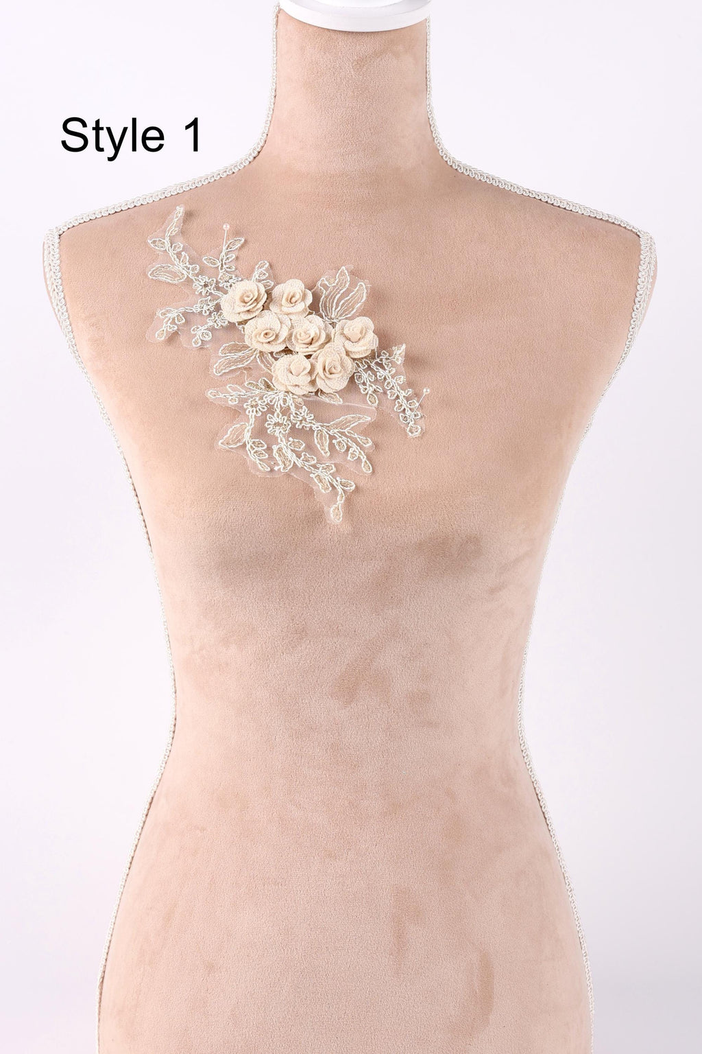 A mannequin with a floral embroidered patch on its chest.