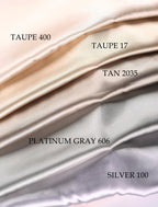a collection of fabric swatches in various shades of gray, ranging from light to dark gray. The swatches are arranged in a gradient, with the light gray at the top, followed by the darker gray, and then the silver gray at the bottom. The swatches are labeled with numbers, indicating the shade of gray, and the text "TAUPE 400", "TAUPE 17", "TAN 2035", "PLATINUM GRAY 606", and "SILVER 100".