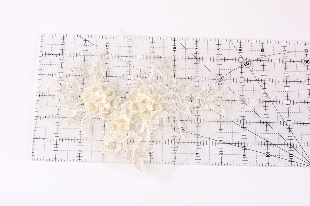 a clear ruler with a floral pattern on it, placed on a white surface.
