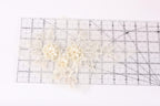 a clear ruler with a floral pattern on it, placed on a white surface.