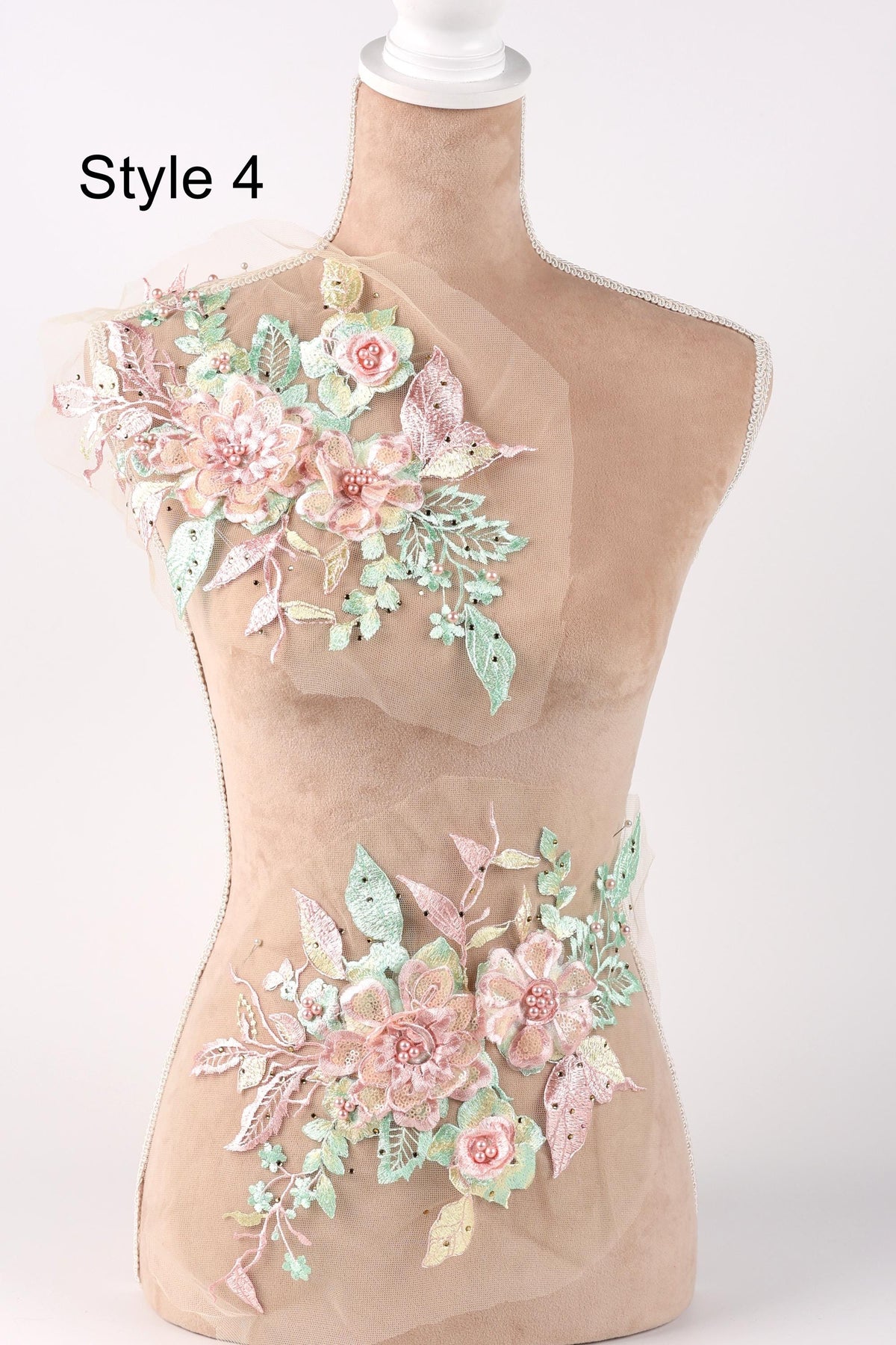 A mannequin with a floral design on its bust and waist area, featuring pink and green flowers and leaves.