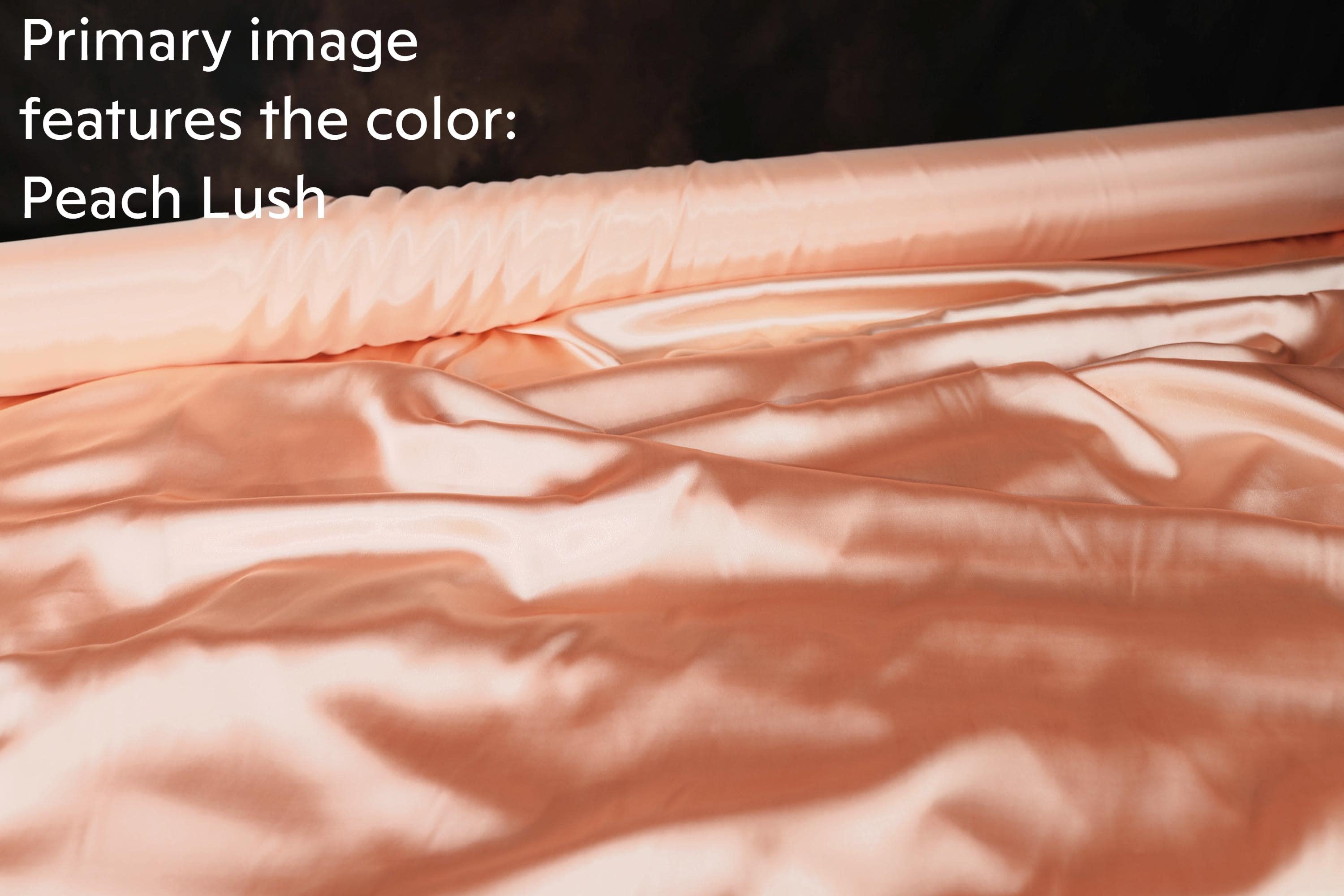 a close-up view of a soft, flowing fabric with a peach-colored hue, which appears to be a satin or satin-like material.