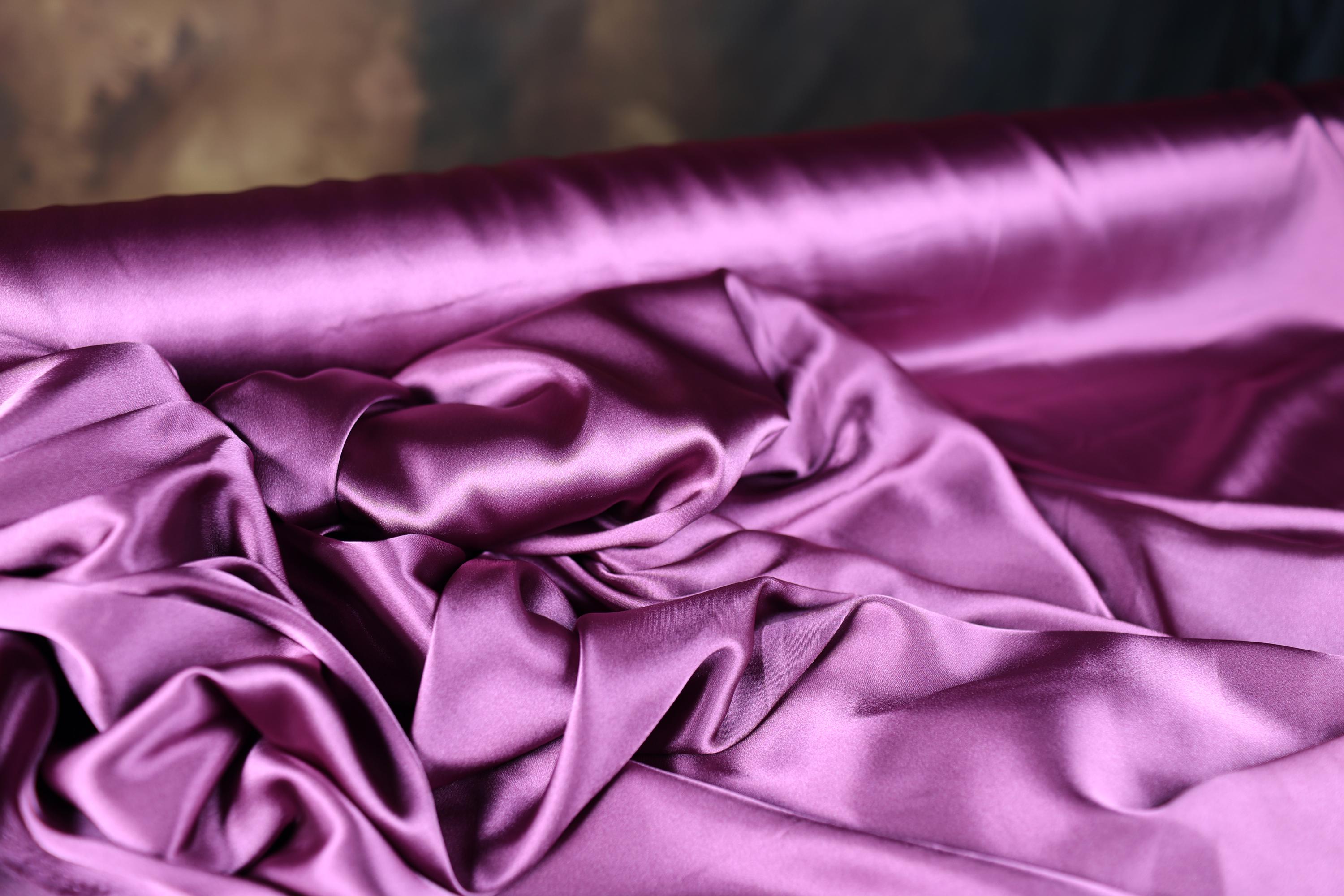 a close up of a purple satin material