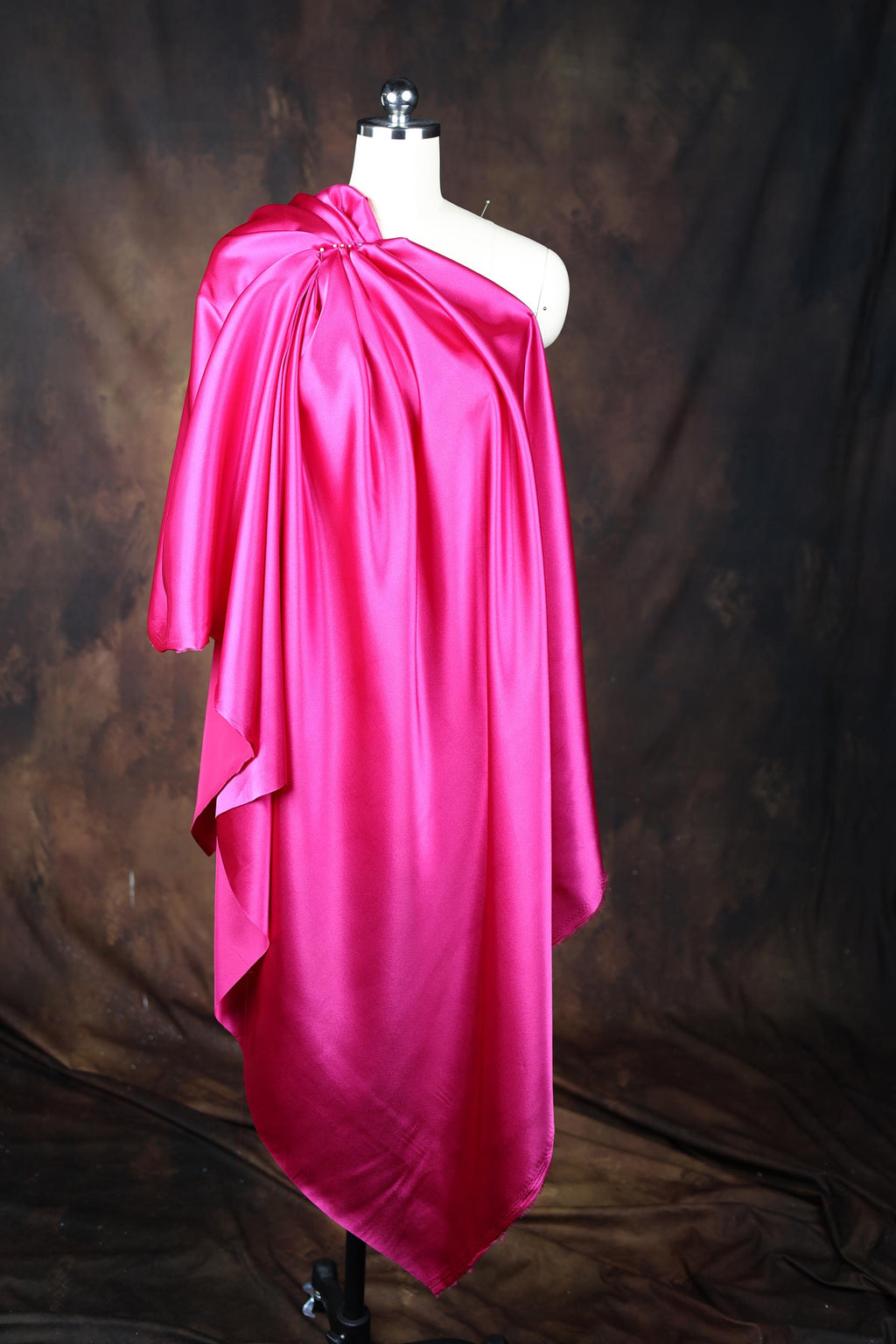 a mannequin is dressed in a pink dress