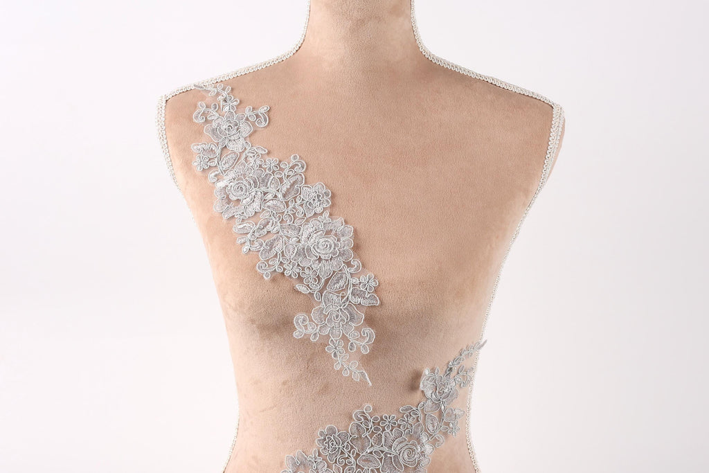 A mannequin with a delicate, intricate lace design on its bust.