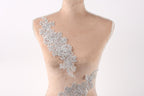 A mannequin with a delicate, intricate lace design on its bust.