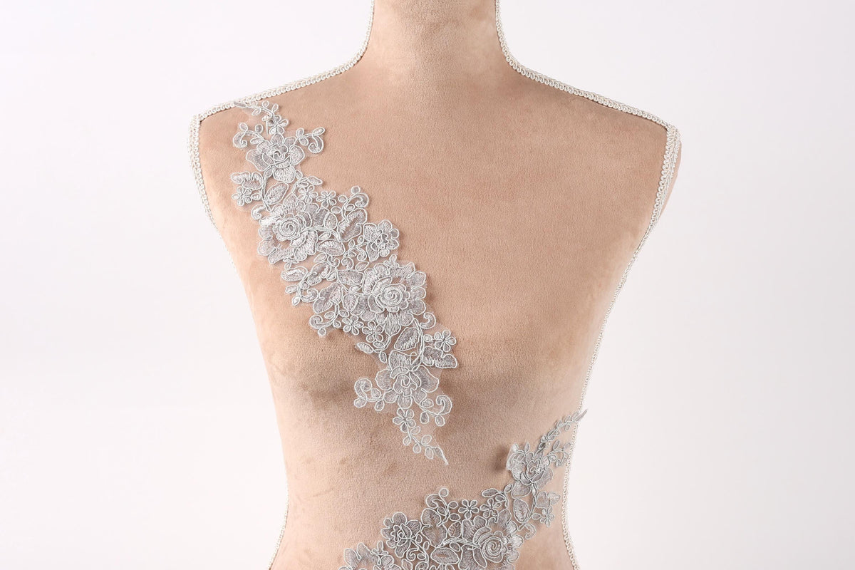 A mannequin with a delicate, intricate lace design on its bust.