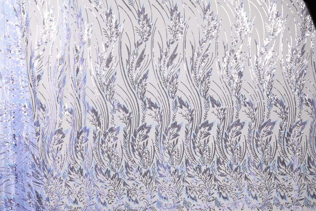 a close-up view of a fabric with a repeating pattern of silver and white leaves or flowers. The pattern is intricate and detailed, creating a visually striking and elegant design.