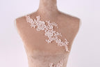 A mannequin with a delicate, lace-like floral pattern on its bust area.