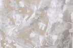 The image is a close-up view of a delicate, white lace fabric with intricate floral patterns. The fabric appears to be made of sheer material, giving it a soft and delicate appearance. The close-up perspective allows for a detailed view of the lace's intricate design and texture.