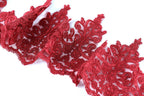 a close-up view of a piece of red lace with intricate floral patterns.