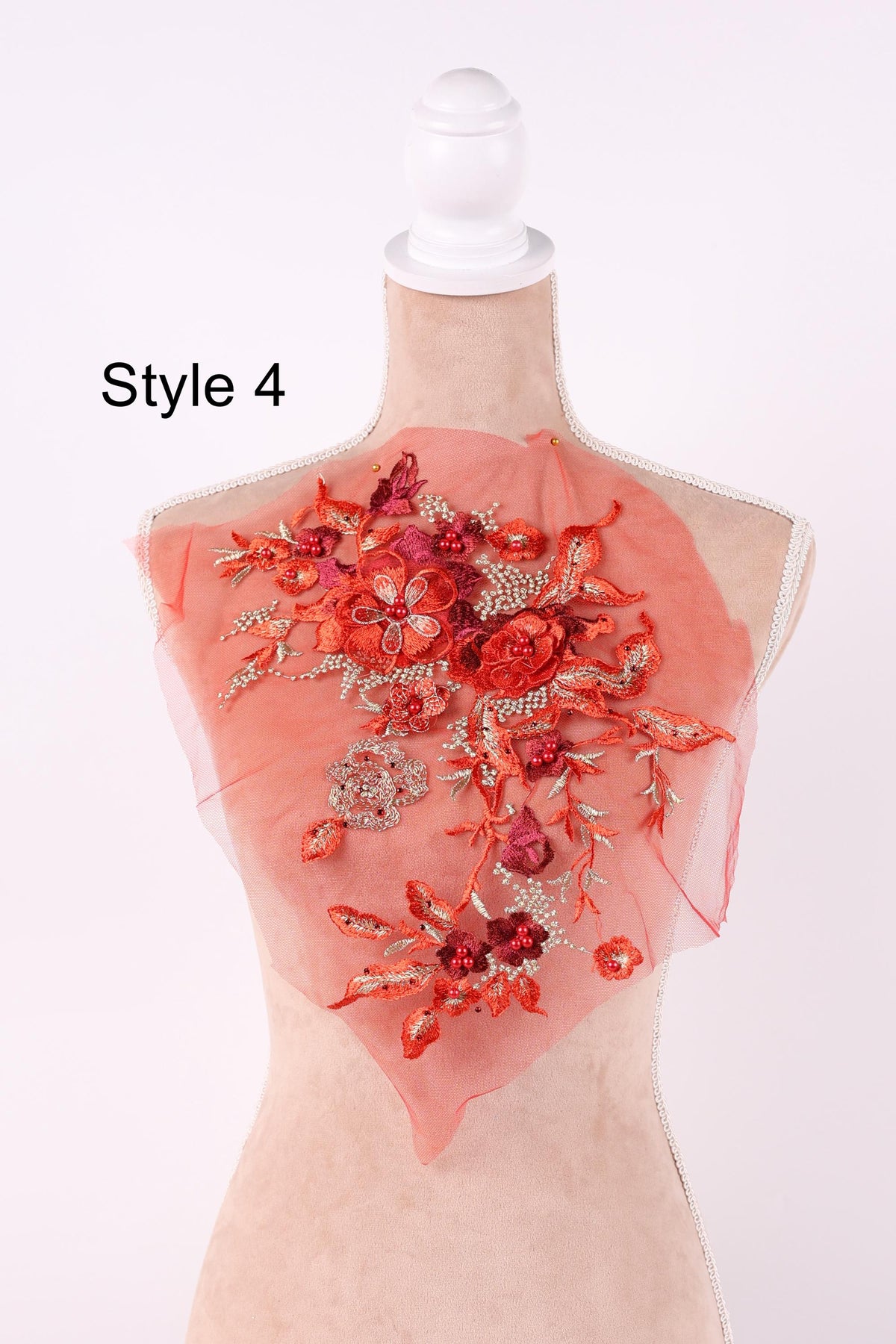 A mannequin wearing a red floral dress with a white headband.