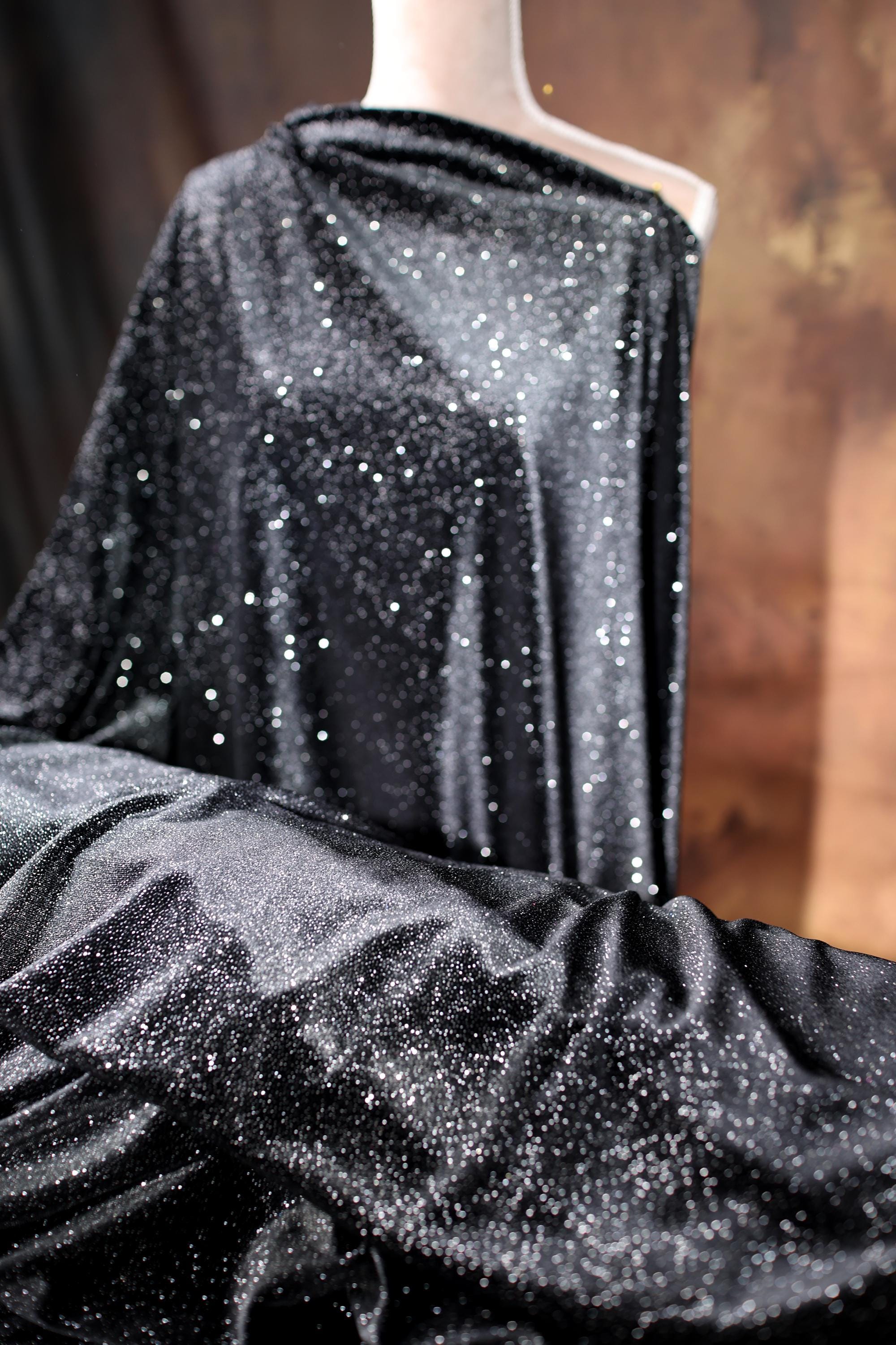 a black dress with silver stars on it