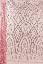 a pink fabric with a repeating pattern of pink and silver sequins or glitter, creating a visually striking and intricate design.