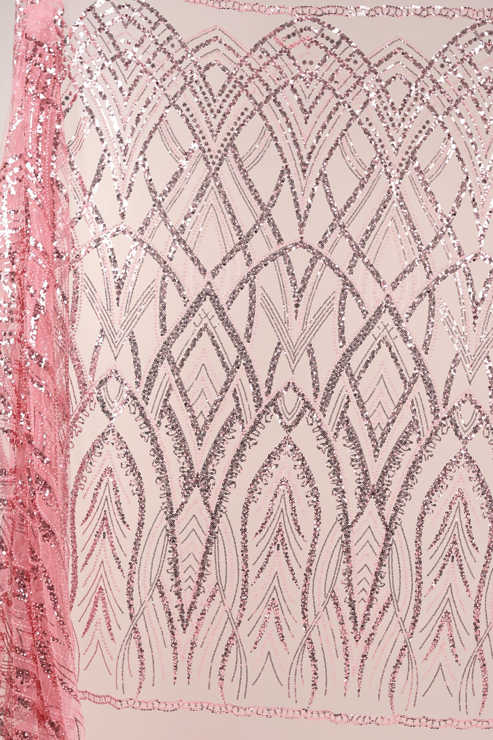 a pink fabric with a repeating pattern of pink and silver sequins or glitter, creating a visually striking and intricate design.