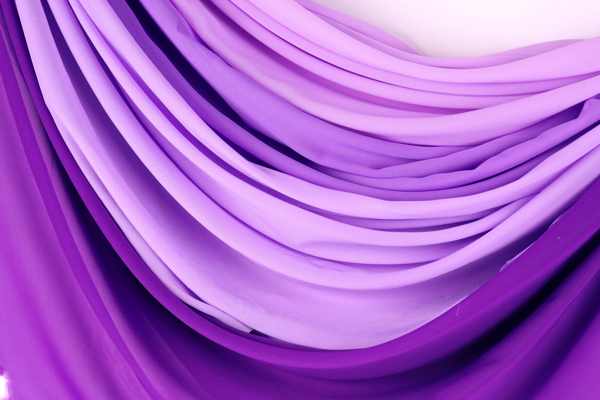 a close-up view of a fabric with a gradient of purple and pink colors, creating a visually appealing and textured appearance.