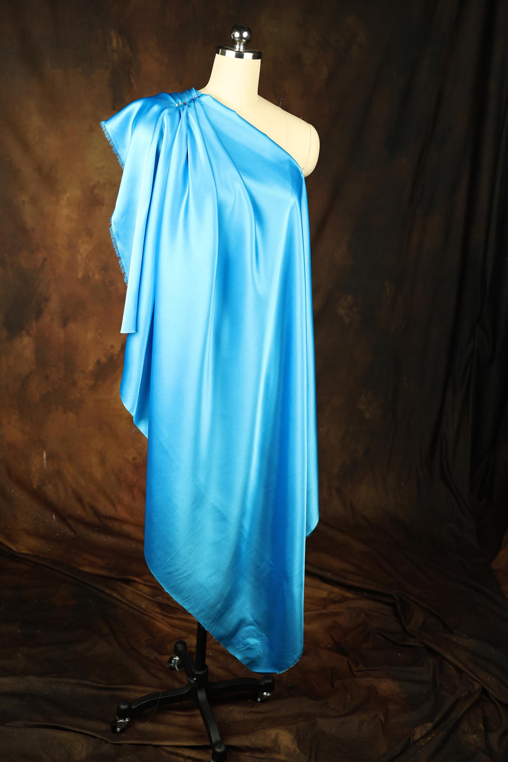 a mannequin is dressed in a blue dress