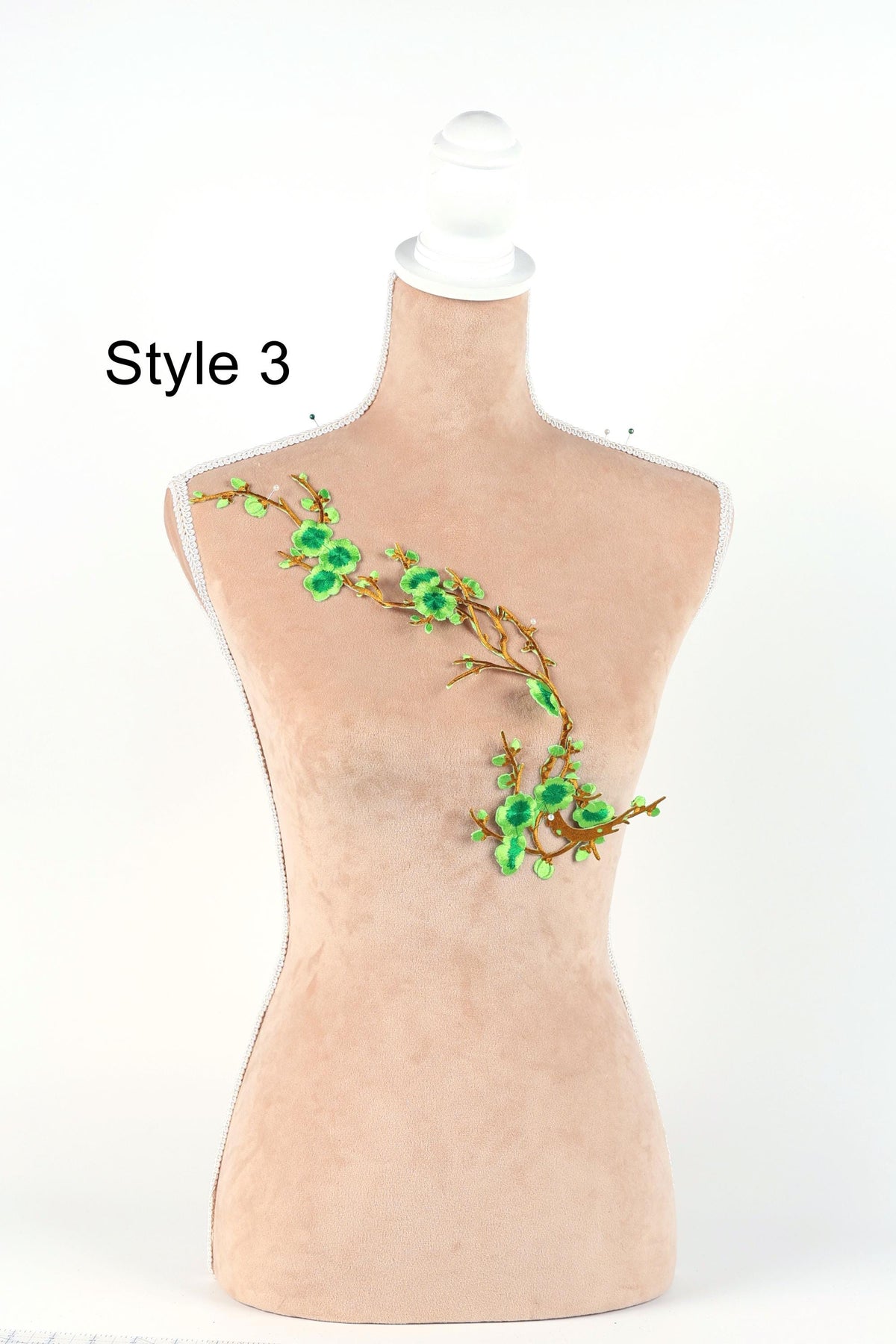 A mannequin with a floral embroidered design on its chest.