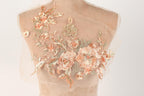 A mannequin bust with a delicate, intricate floral embroidery design on the back.