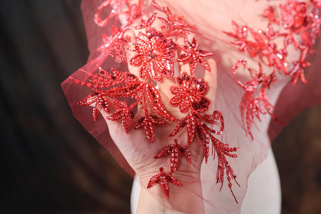 a close up of a dress with red sequins