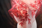 a close up of a dress with red sequins