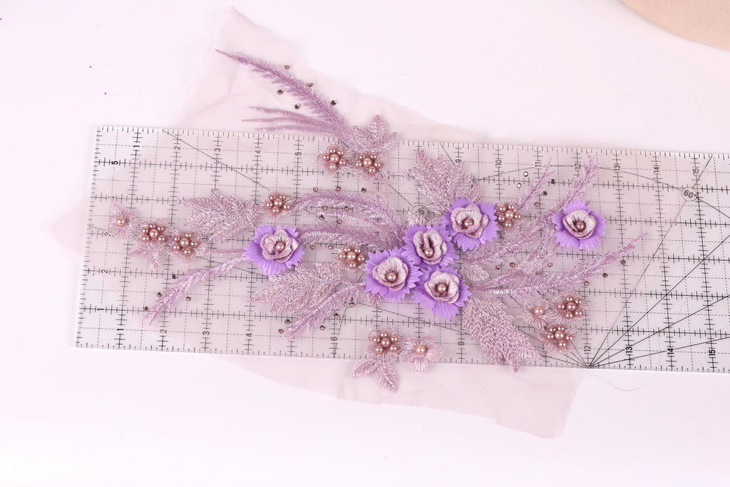 a clear ruler with a floral design on it, including purple flowers and leaves.