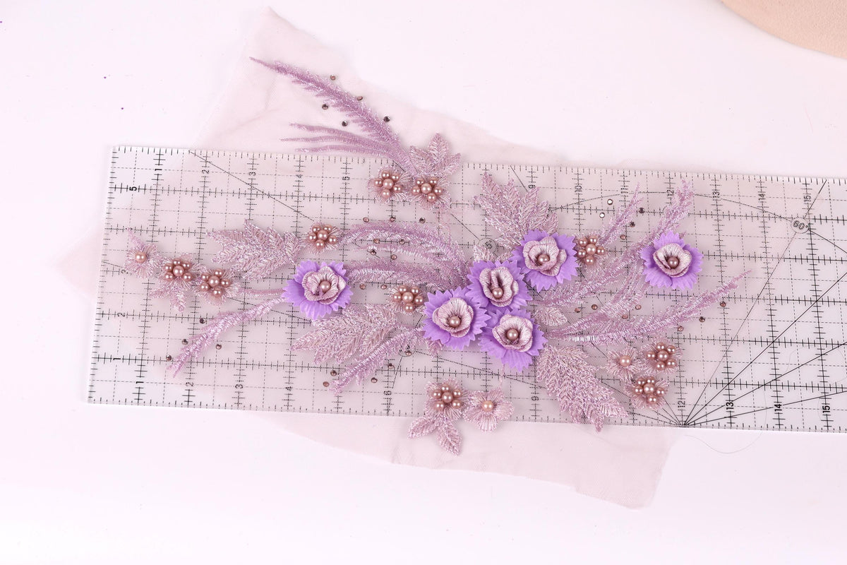a clear ruler with a floral design on it, including purple flowers and leaves.