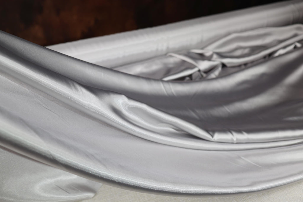 a close up of a bed with a white sheet