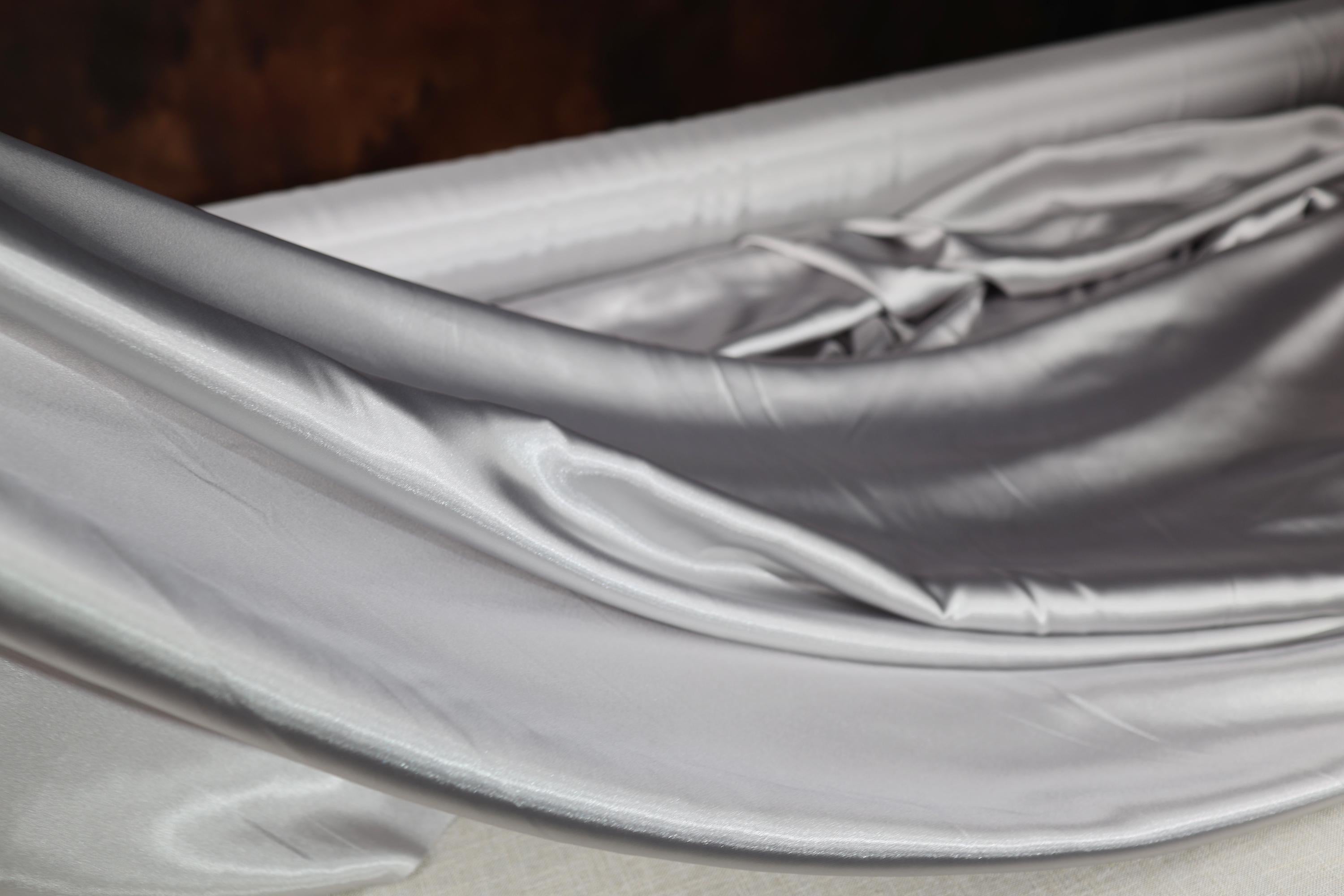 a close up of a bed with a white sheet
