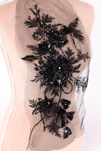 a close-up view of a delicate, intricate black lace design with a floral pattern.