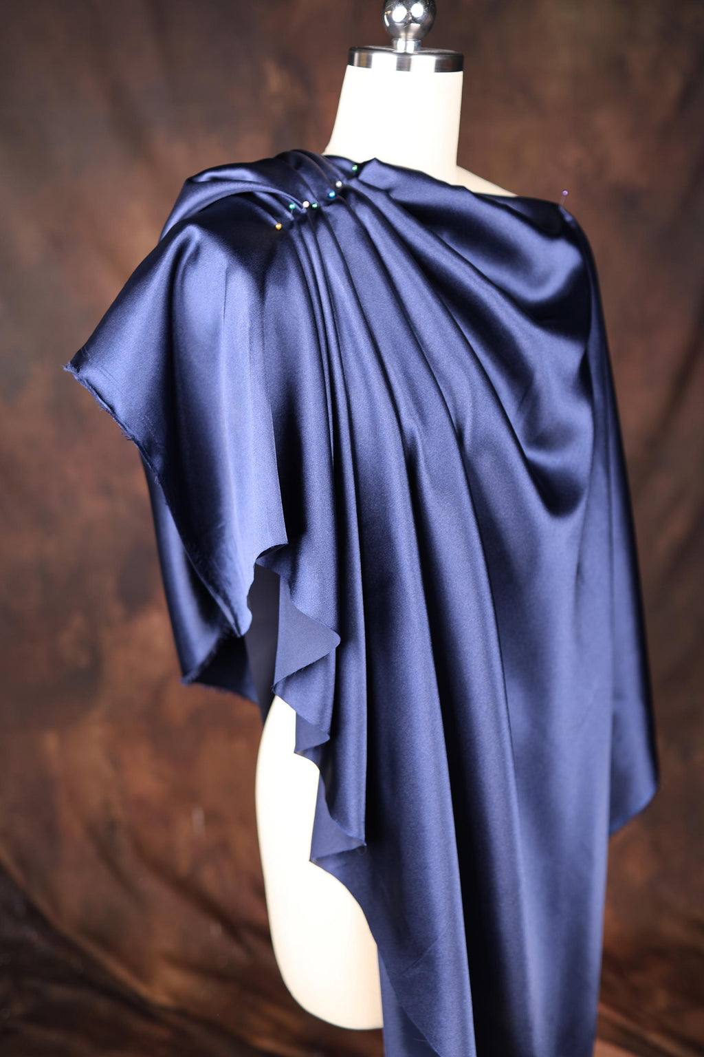 a mannequin with a blue cape on top of it