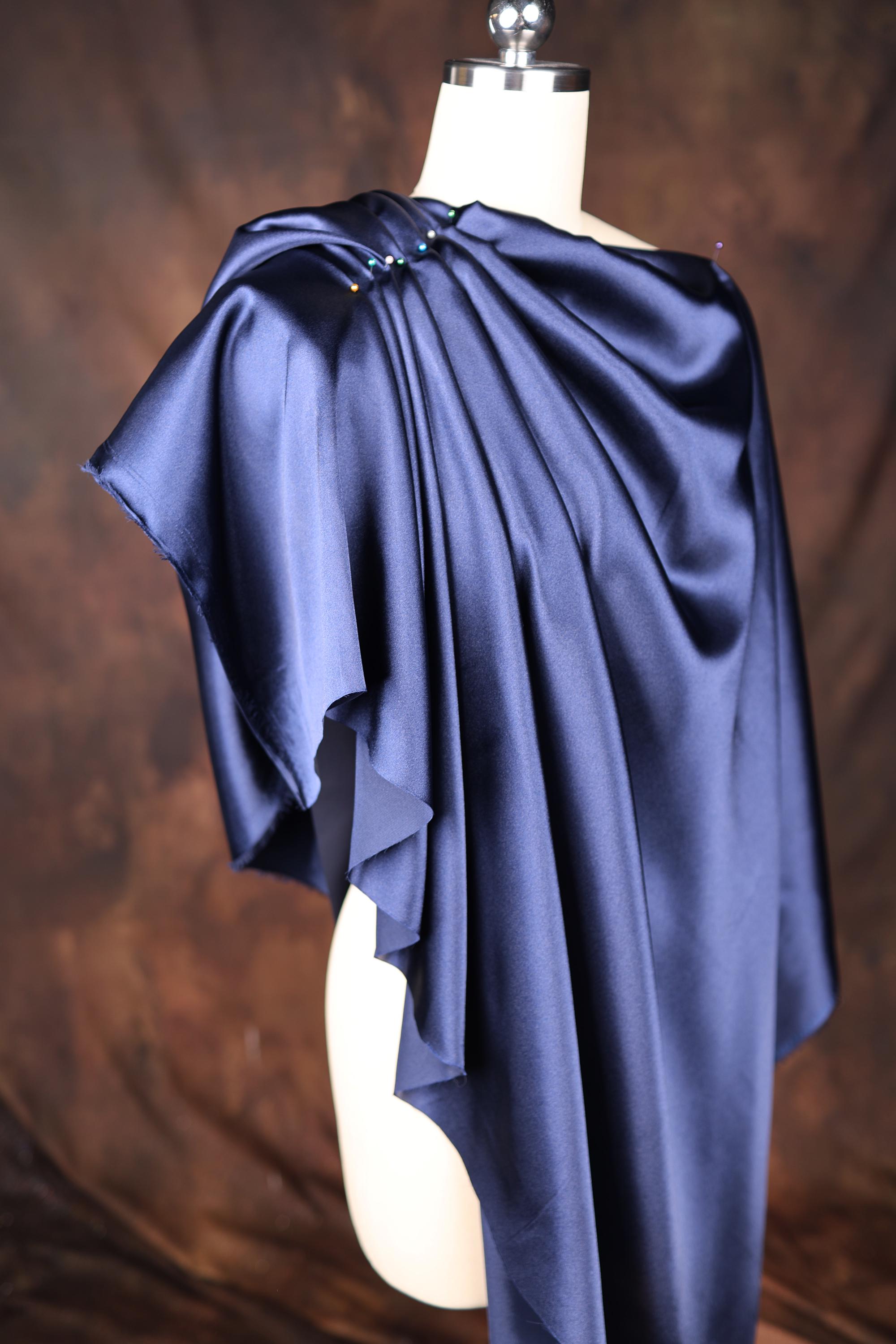 a mannequin with a blue cape on top of it
