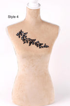A mannequin with a decorative leaf pattern on its bust.