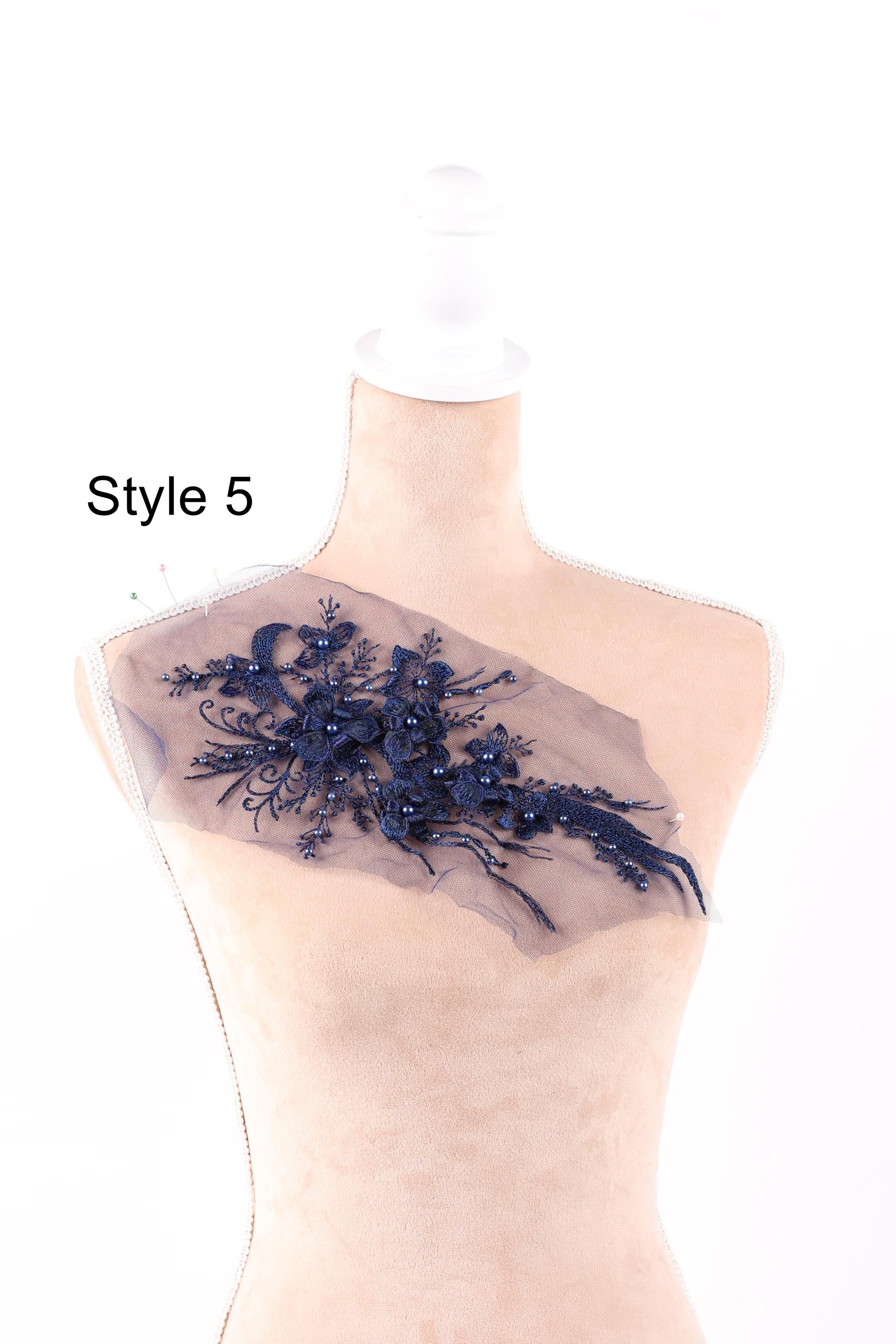 A mannequin with a decorative fabric piece on its bust, featuring a floral pattern in navy blue.