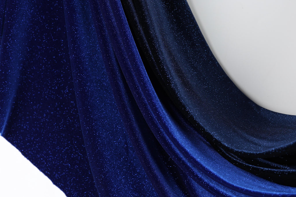 a close-up view of a shiny, blue fabric with a sparkling texture.
