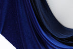 a close-up view of a shiny, blue fabric with a sparkling texture.