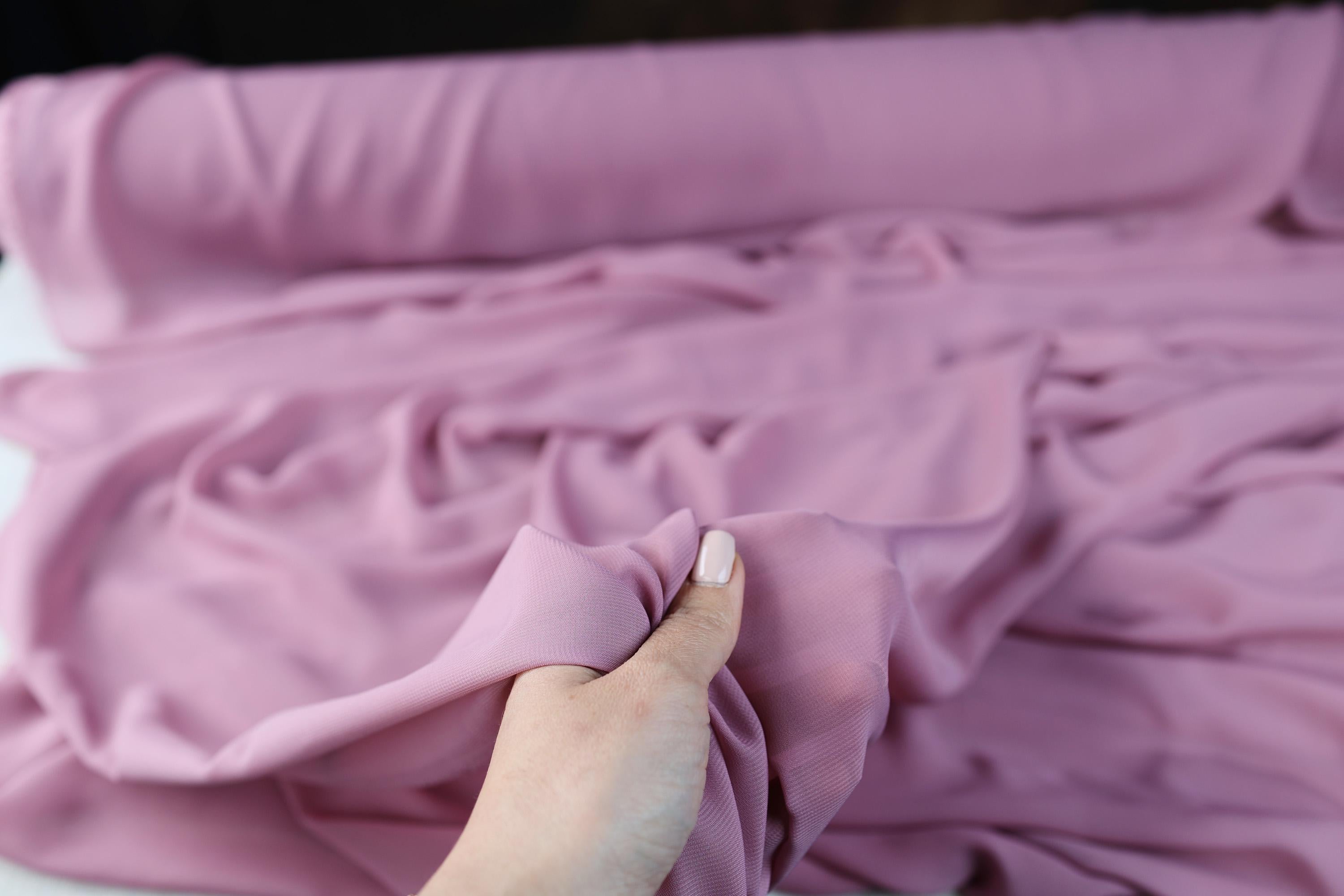 a person holding a cloth over a piece of cloth