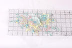 a clear ruler with a floral design on it, including various colored flowers and leaves.