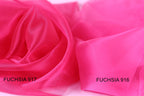 two close-up views of a soft, shiny pink fabric, with the text "FUCHSIA 917" and "FUCHSIA 916" visible on the fabric.