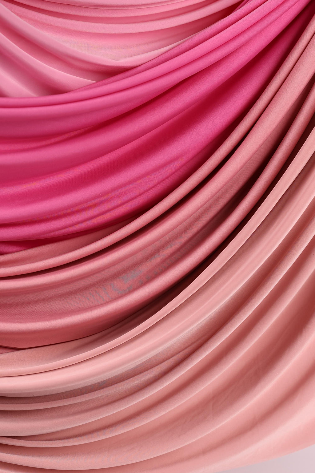 a close-up view of a fabric with a pink and peach color gradient, creating a visually appealing and textured appearance.