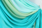 a close-up view of a fabric with a gradient of blue and green colors, creating a visually appealing and textured appearance.