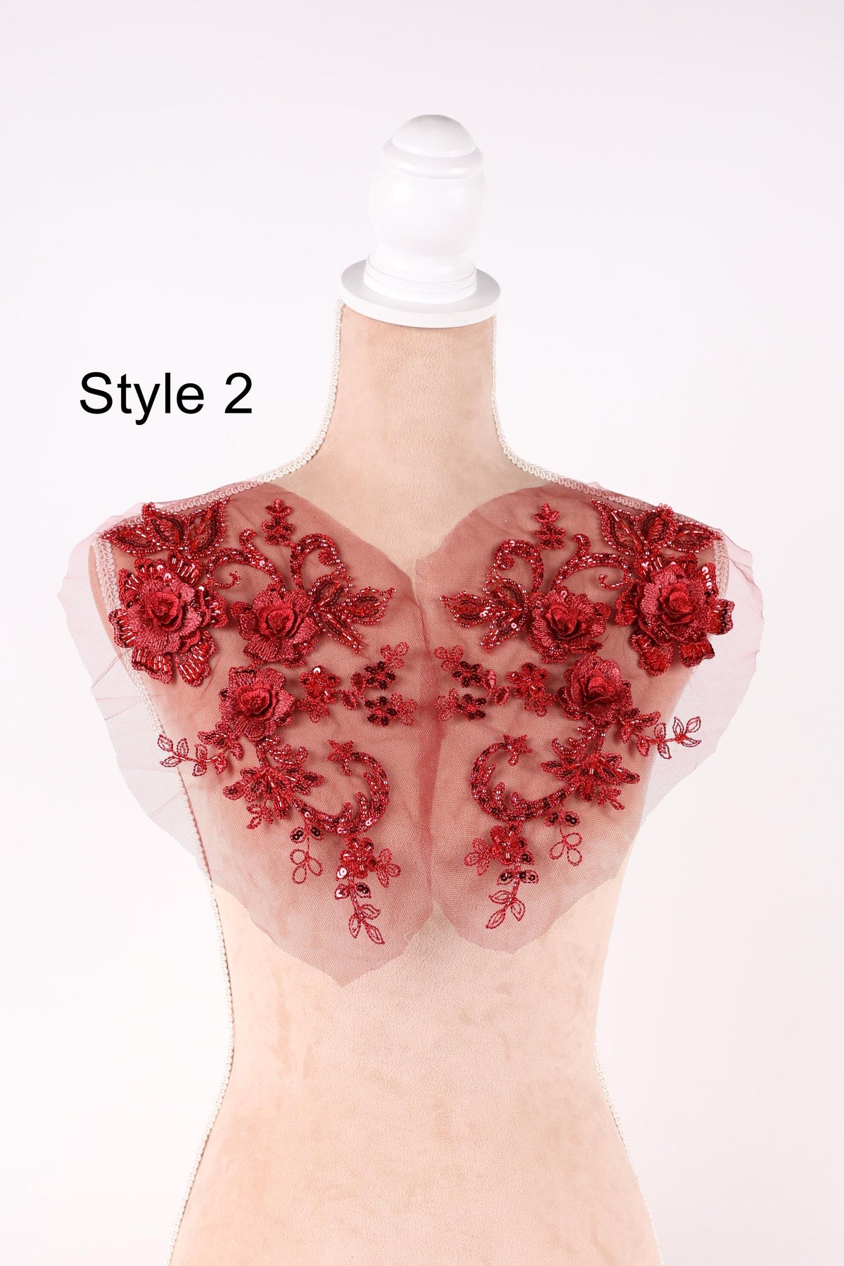 A mannequin with red floral embellishments on its shoulders, labeled as "Style 2".
