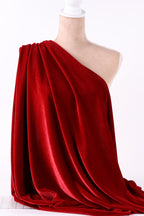 a red velvet fabric draped over a mannequin head.