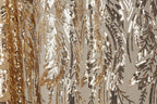 a close-up view of a fabric with a gold and black sequin pattern. The fabric appears to be a sheer material, with the sequins arranged in a repeating pattern that creates a visually striking and intricate design.