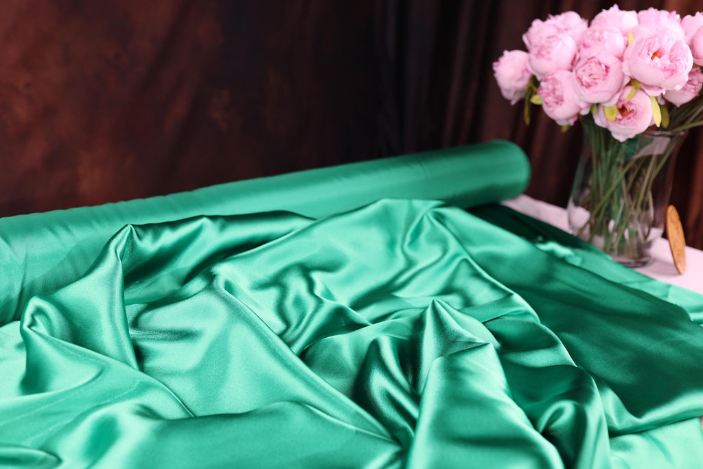 a vase filled with pink flowers sitting on top of a table