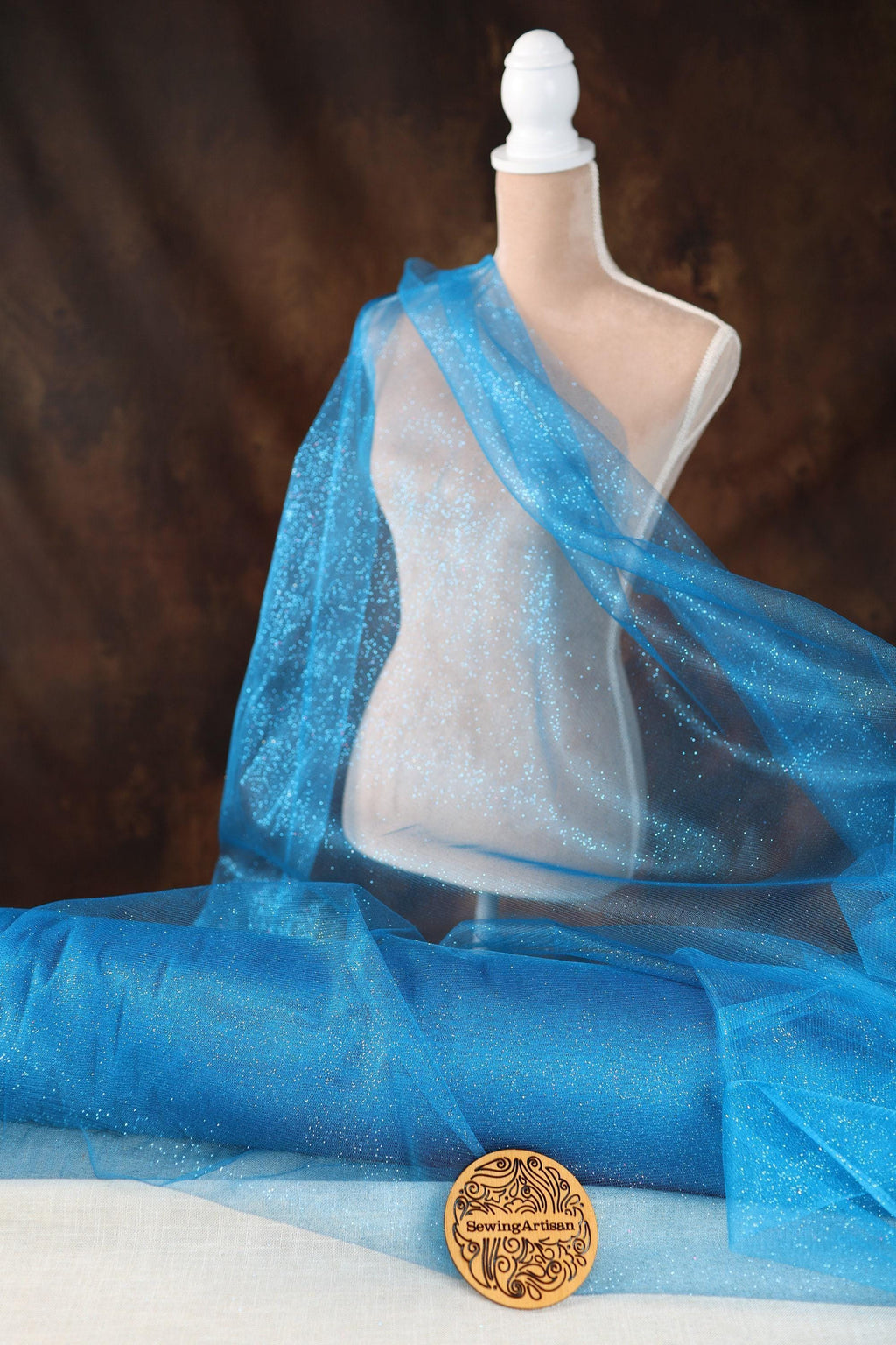 a close up of a mannequin wearing a blue scarf